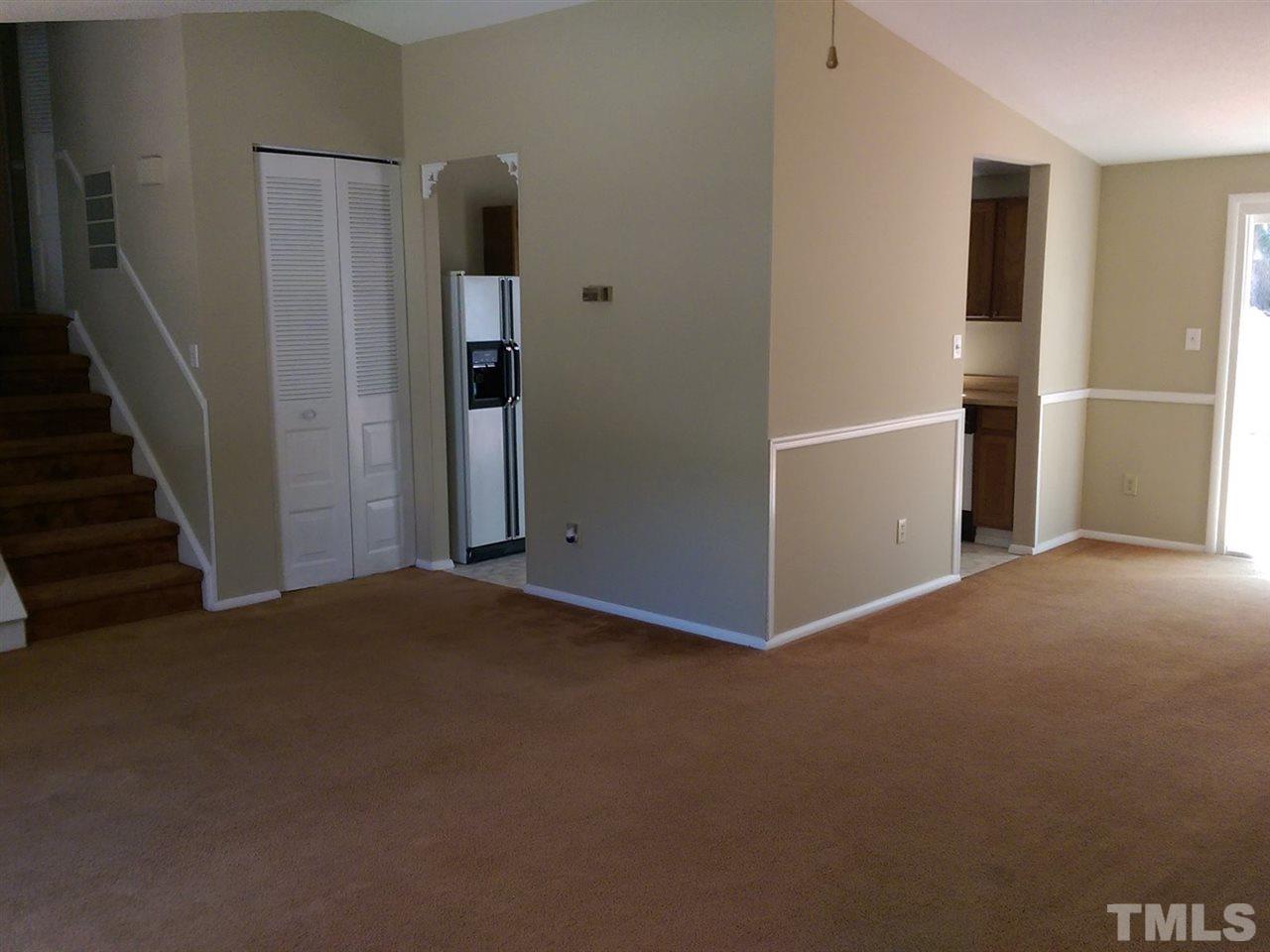 7909 Janet Court Raleigh, NC 27615 - Photo 4 of 25 a view of an empty room with wooden floor and entryway