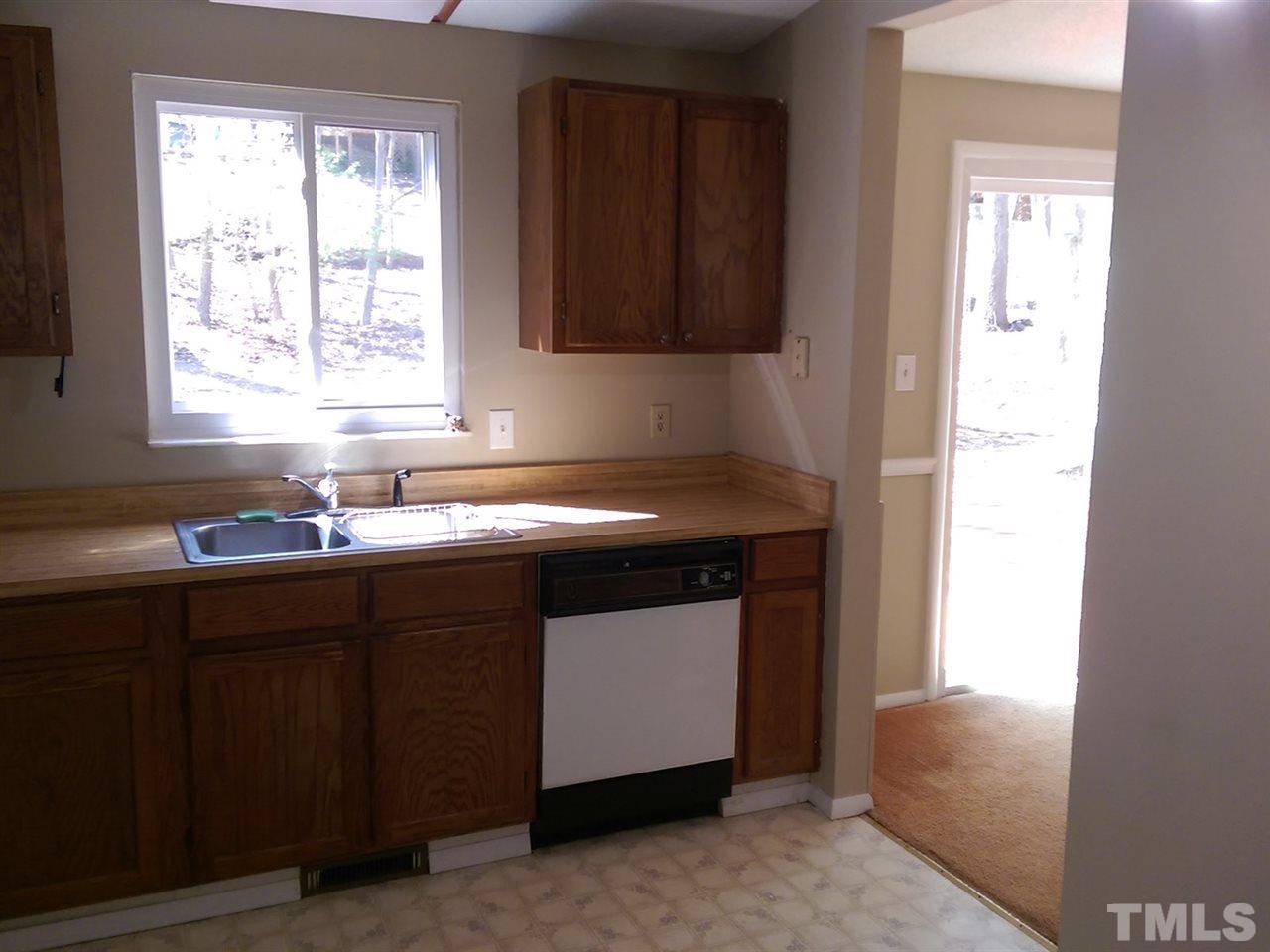 7909 Janet Court Raleigh, NC 27615 - Photo 5 of 25 a kitchen with a sink cabinets and window