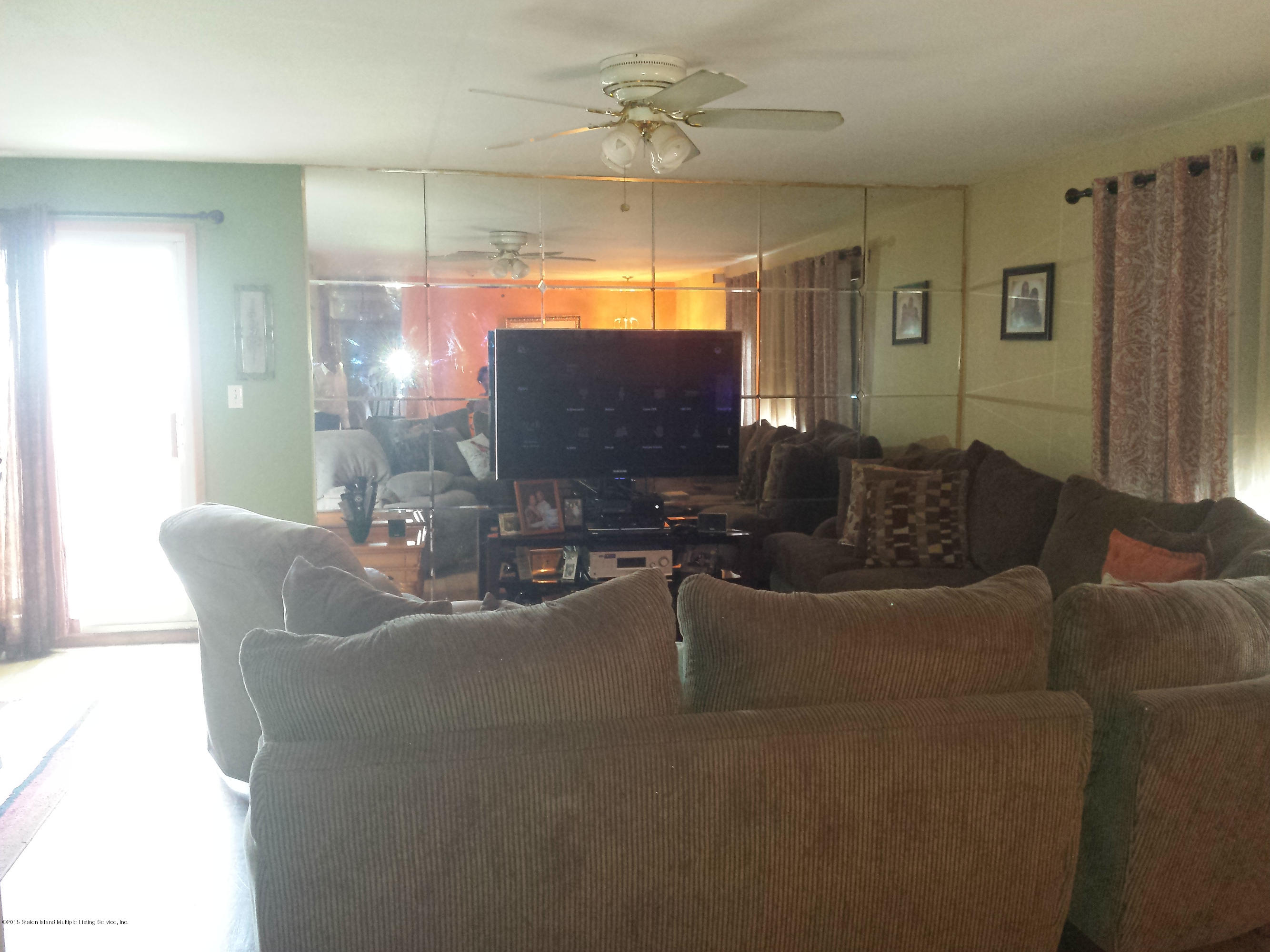 9 Manor Road Staten Island, NY 10310 - Photo 6 of 6 a living room with furniture and a flat screen tv