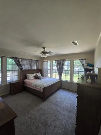 a bed room with a bed and a large window