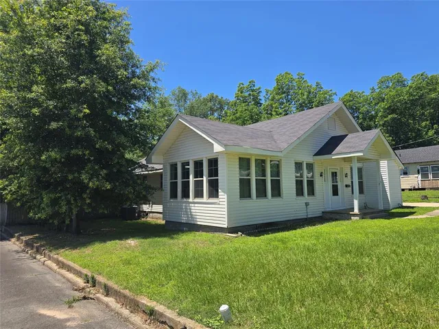 a view of a house with garden and yard
