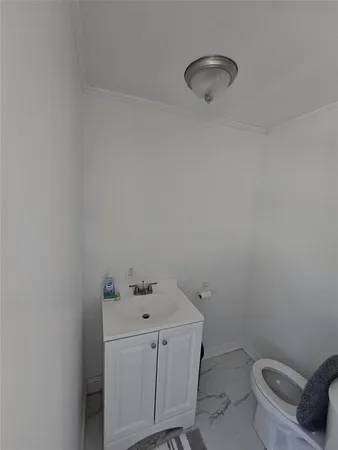 a bathroom with a toilet sink and vanity