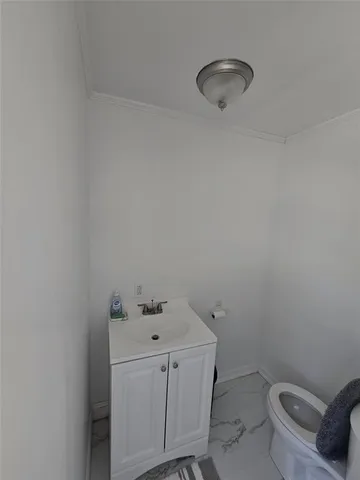 a bathroom with a toilet sink and vanity