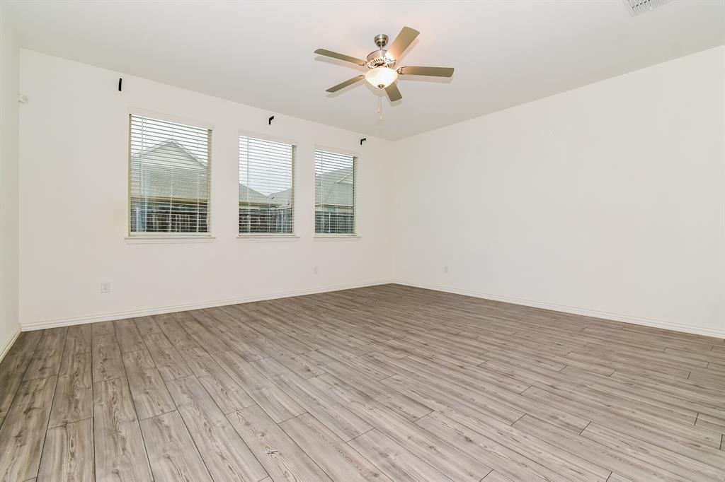 1208 Mesquite Lane Princeton, TX 75407 - Photo 2 of 17 a view of empty room with wooden floor and fan