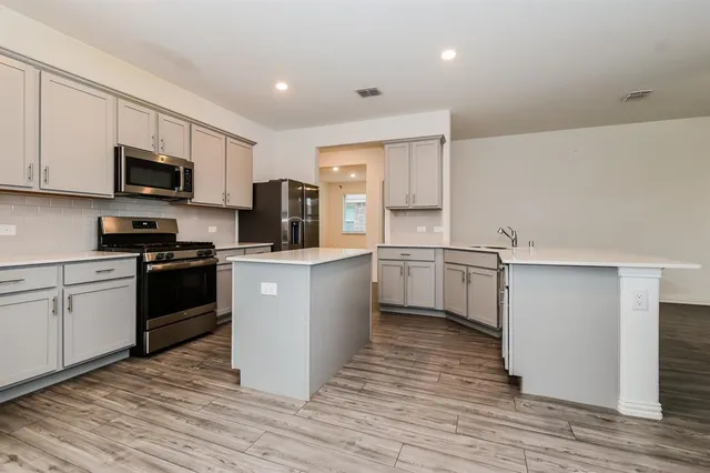 a kitchen with a white cabinets and white appliances