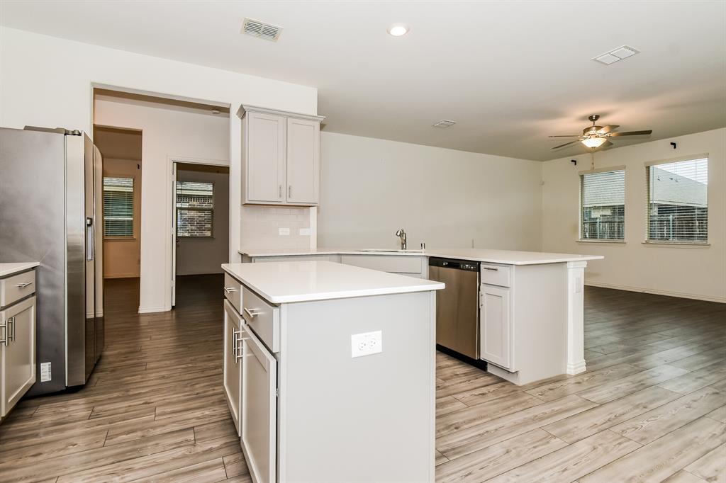 1208 Mesquite Lane Princeton, TX 75407 - Photo 6 of 17 a kitchen with a stove a refrigerator and a sink