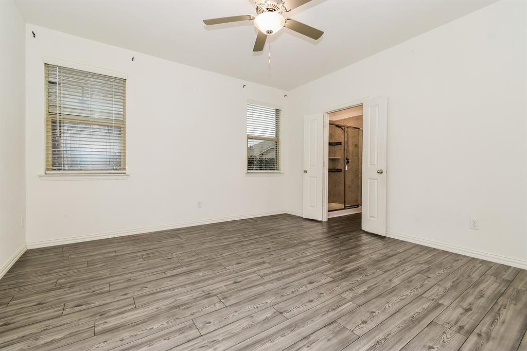 1208 Mesquite Lane Princeton, TX 75407 - Photo 7 of 17 a view of an empty room with wooden floor and a window