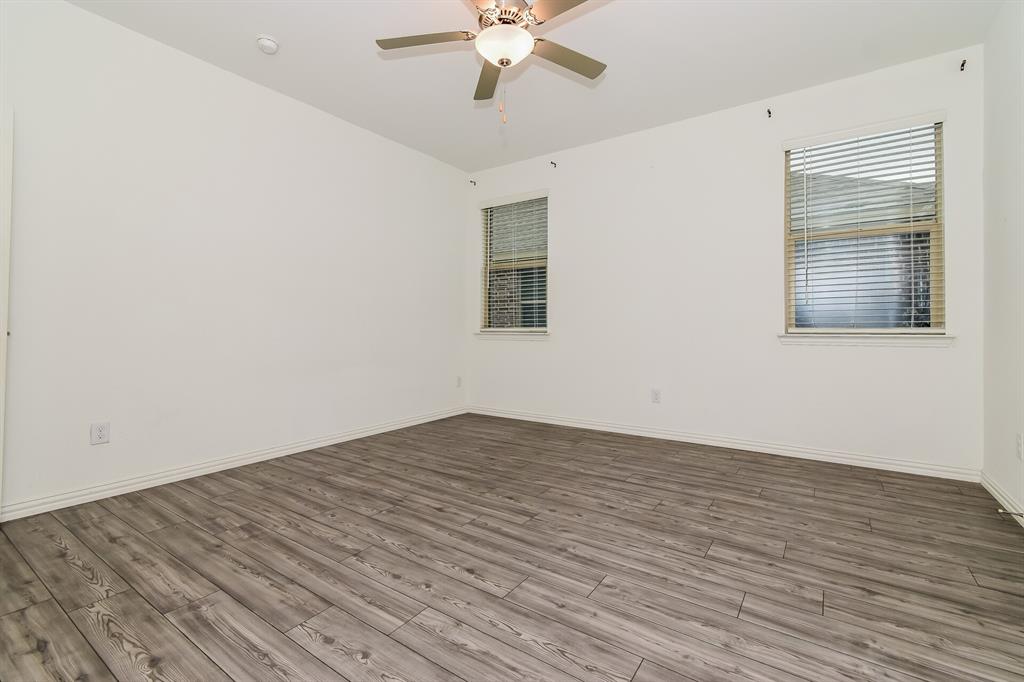 1208 Mesquite Lane Princeton, TX 75407 - Photo 8 of 17 wooden floor in an empty room with a window