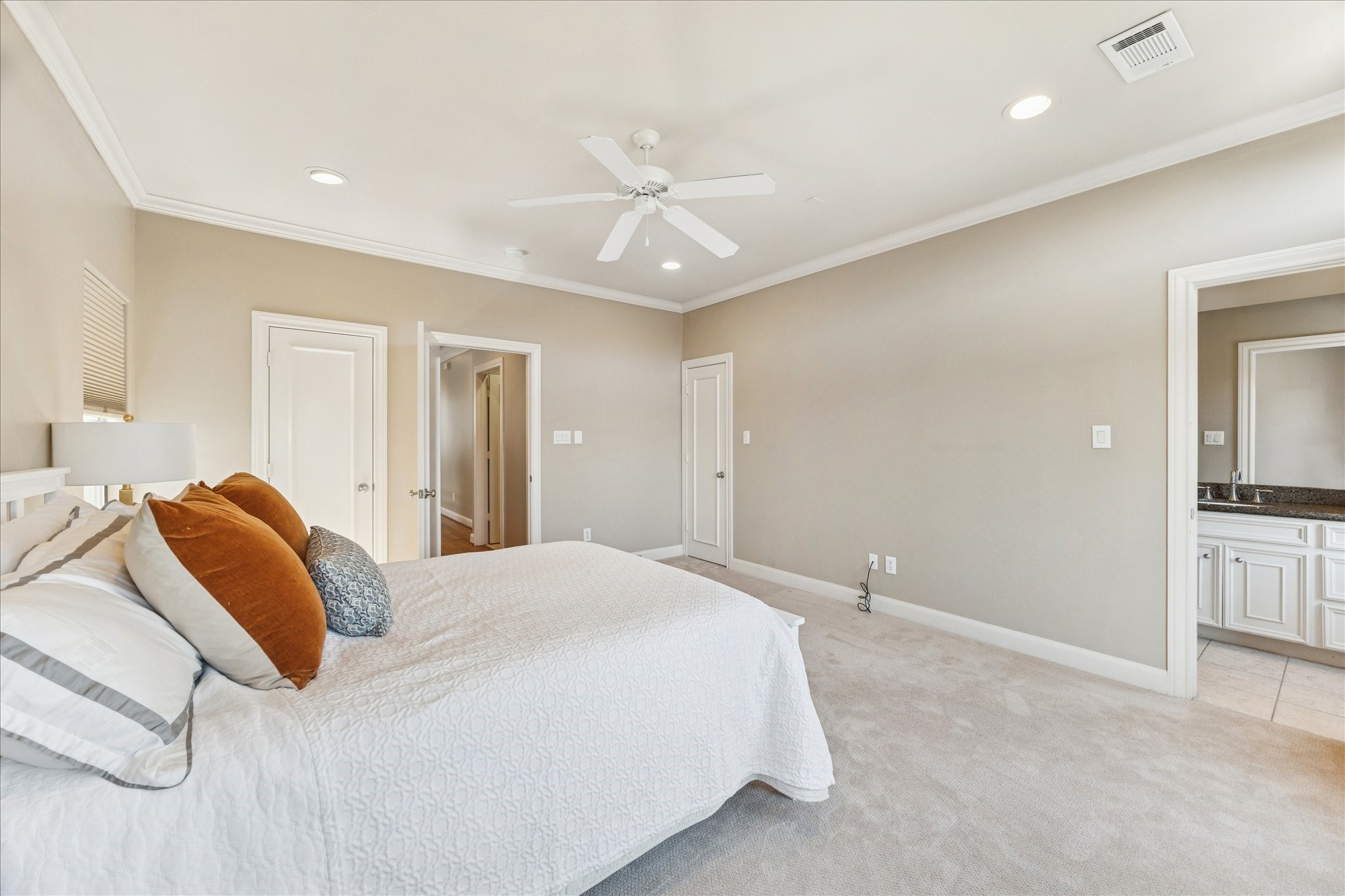 1712 McDuffie Street Houston, TX 77019 - Photo 18 of 27 a bedroom with a large bed and ceiling fan