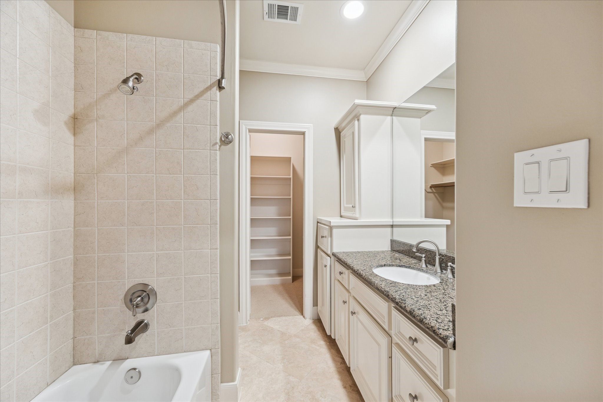 1712 McDuffie Street Houston, TX 77019 - Photo 21 of 27 a bathroom with a granite countertop sink a mirror and a bathtub