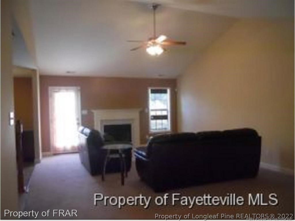 2165 Yellowbrick Road Fayetteville, NC 28314 - Photo 4 of 7 a living room with furniture a fireplace and a potted plant
