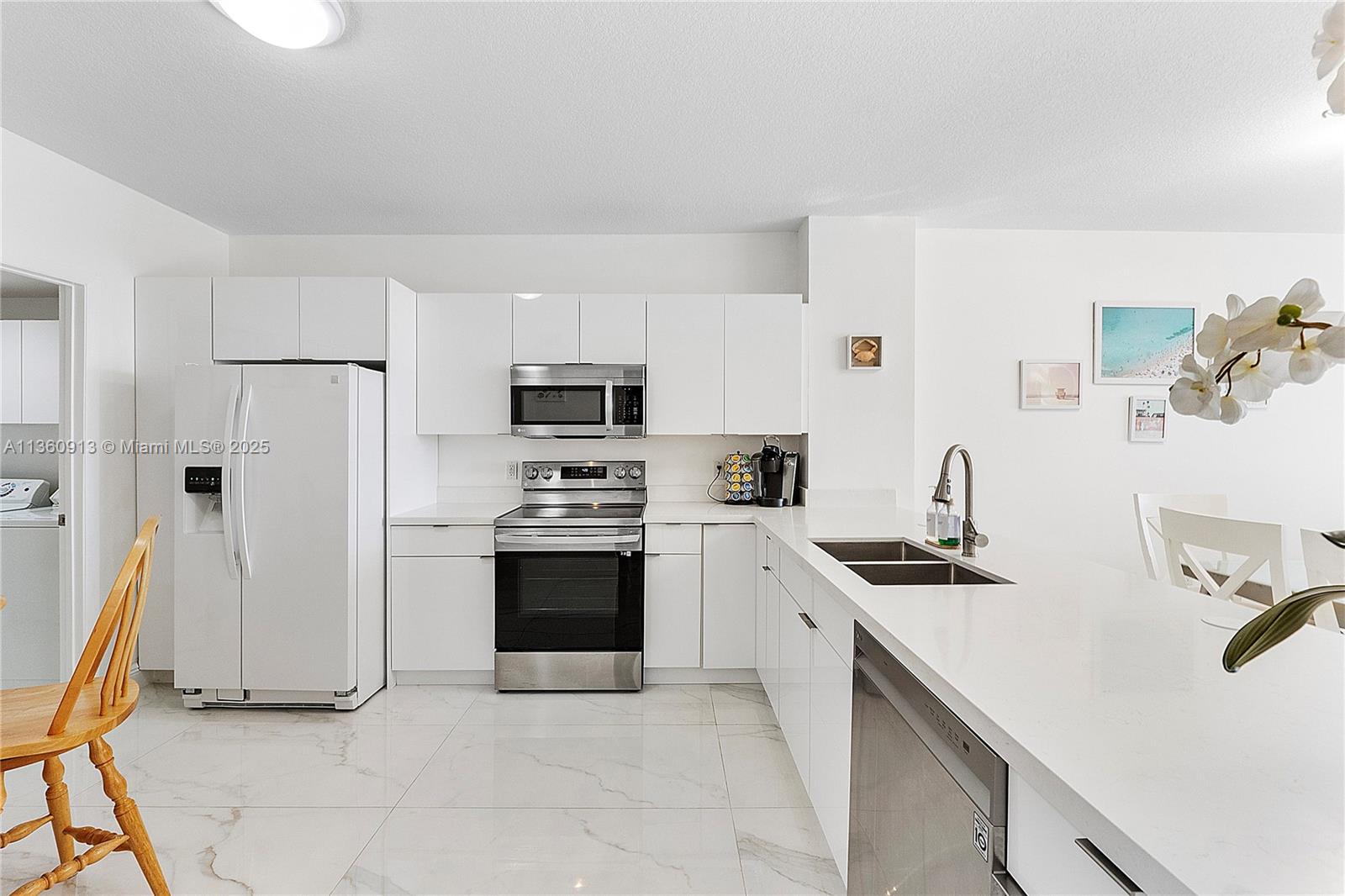 17050 North Bay Road, Unit 807 Sunny Isles Beach, FL 33160 - Photo 12 of 50 a kitchen with stainless steel appliances a stove a sink and a refrigerator