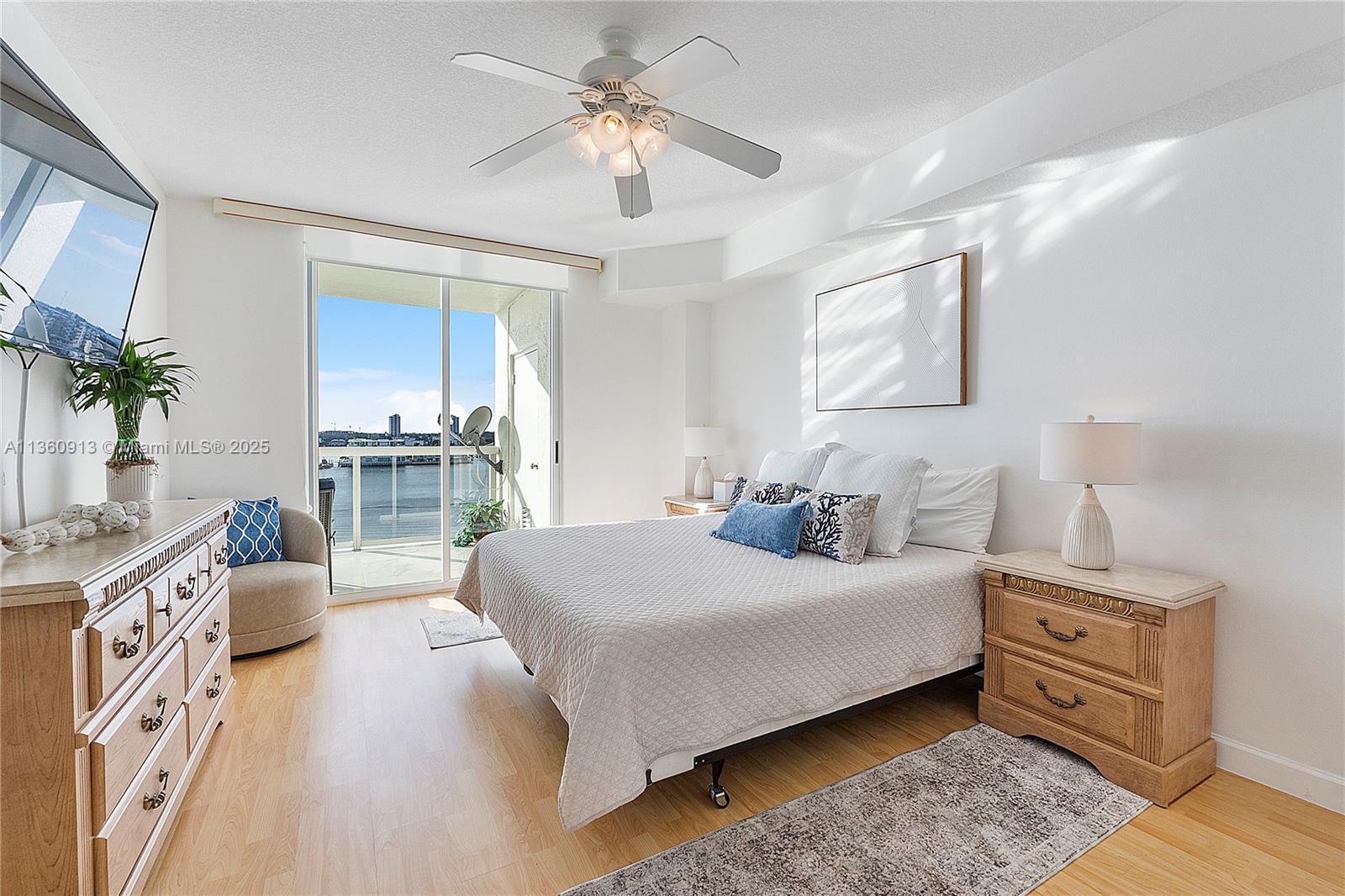 17050 North Bay Road, Unit 807 Sunny Isles Beach, FL 33160 - Photo 14 of 50 a bedroom with a large bed and a chandelier