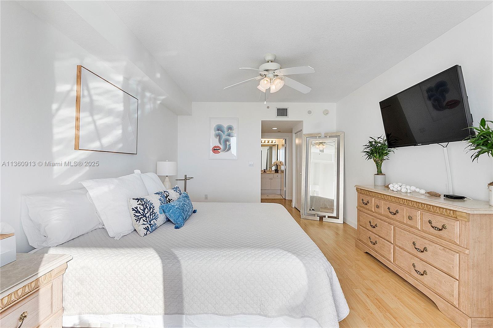 17050 North Bay Road, Unit 807 Sunny Isles Beach, FL 33160 - Photo 15 of 50 a bedroom with a large bed and a flat screen tv