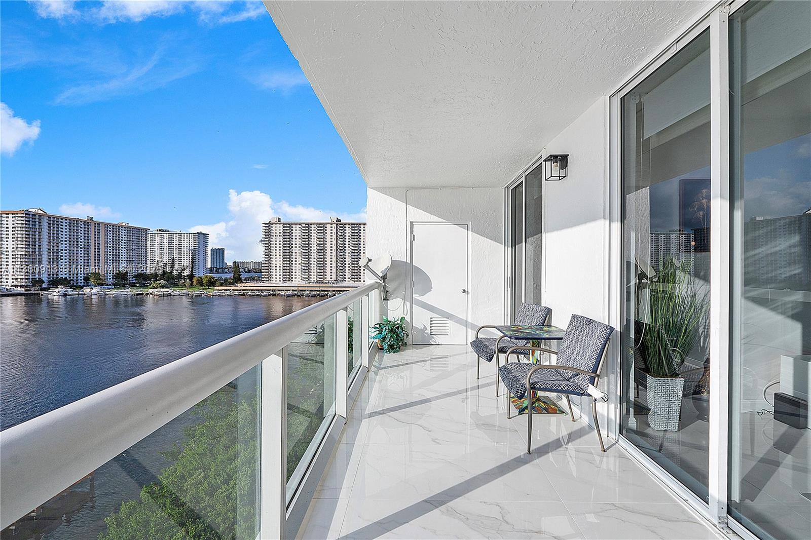 17050 North Bay Road, Unit 807 Sunny Isles Beach, FL 33160 - Photo 21 of 50 a balcony with table and chairs