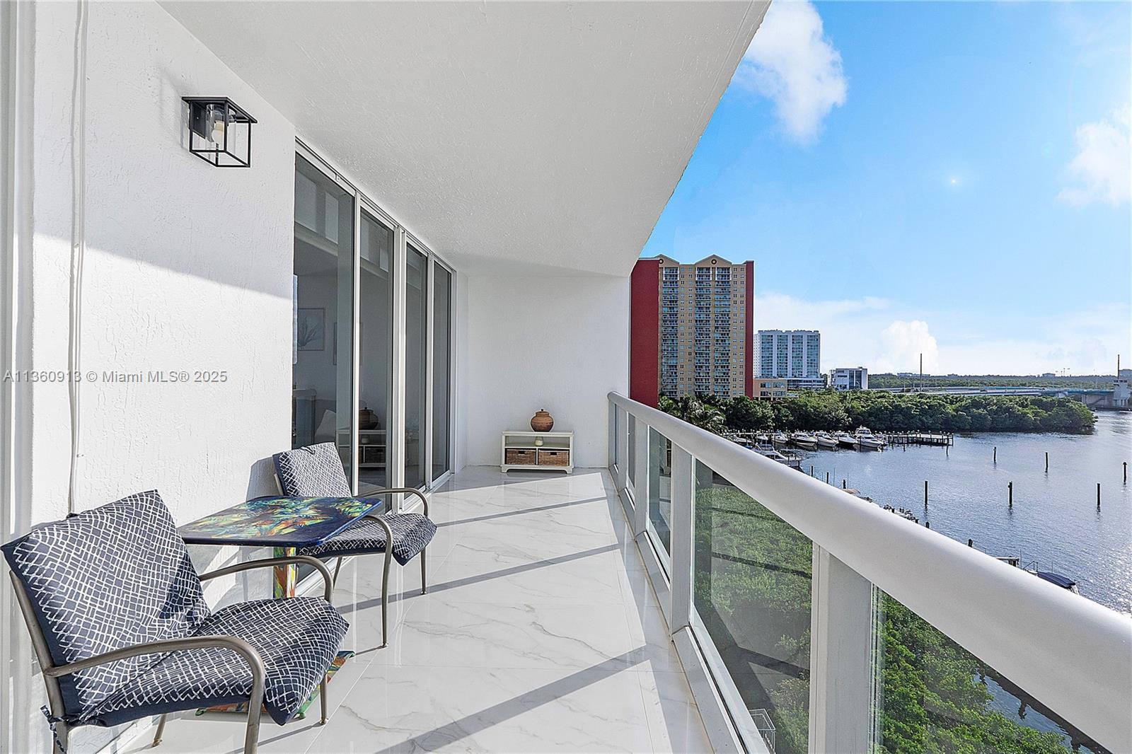 17050 North Bay Road, Unit 807 Sunny Isles Beach, FL 33160 - Photo 22 of 50 a balcony with furniture and city view