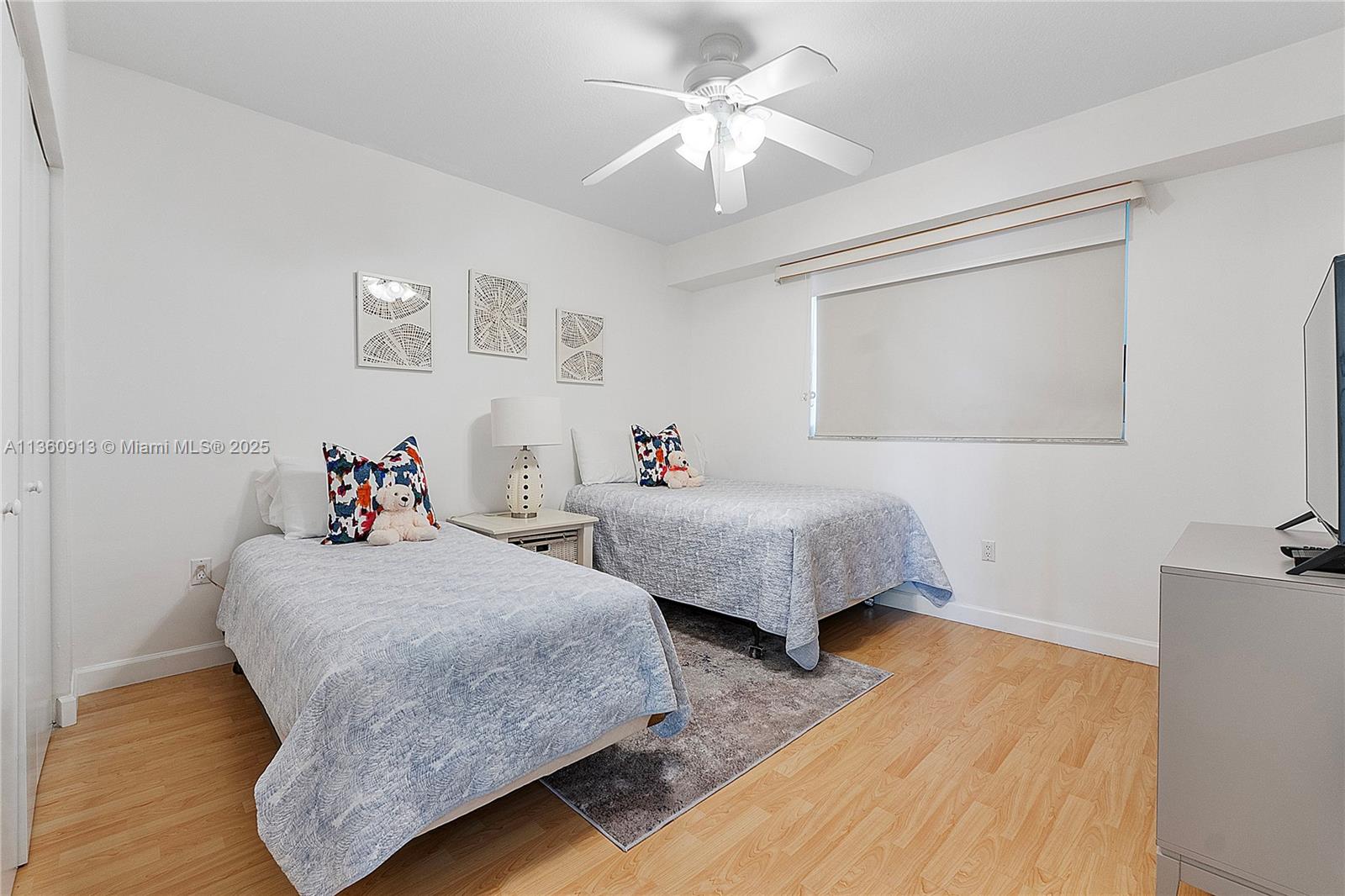 17050 North Bay Road, Unit 807 Sunny Isles Beach, FL 33160 - Photo 24 of 50 a bedroom with two beds and a chandelier