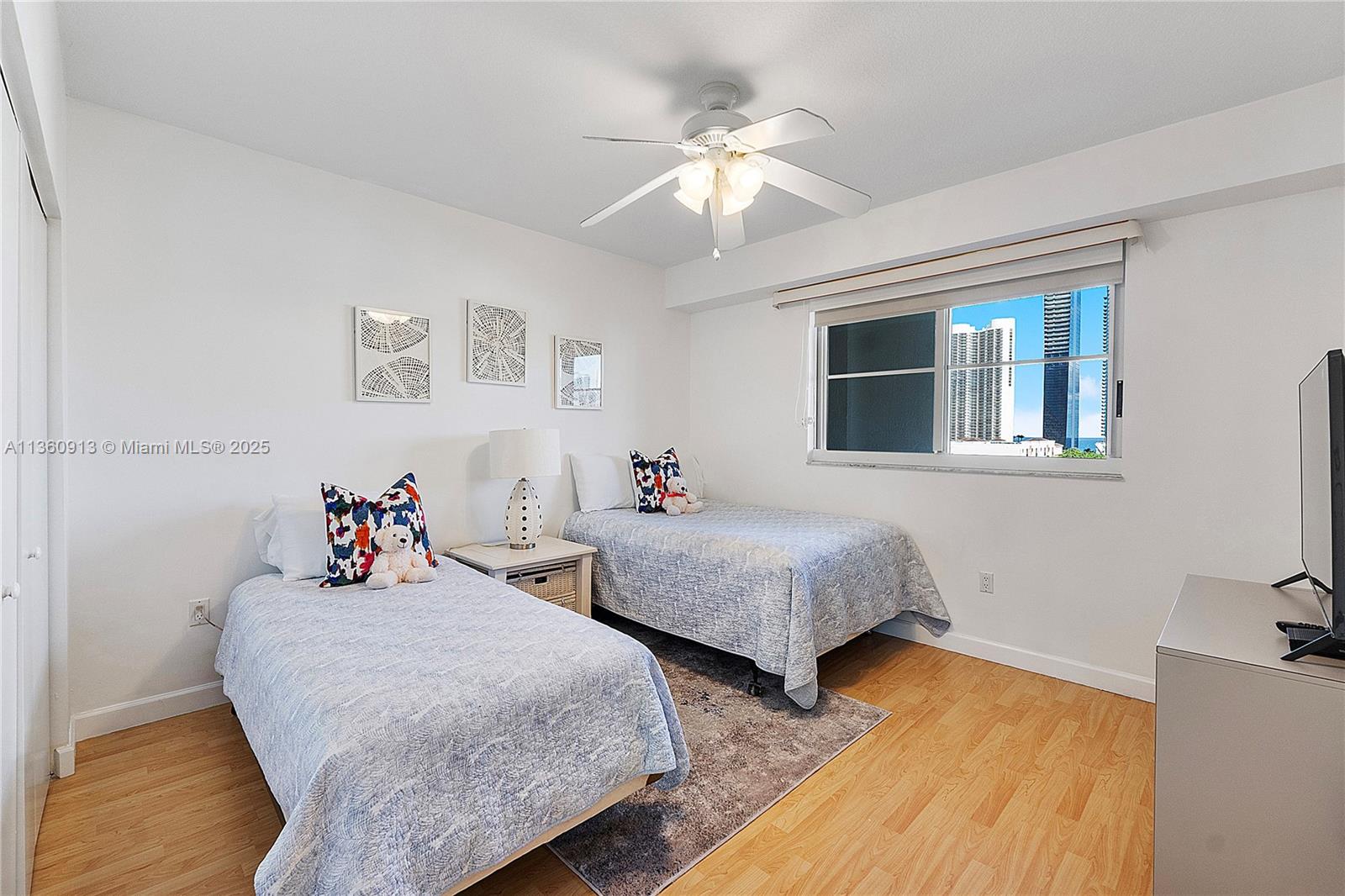 17050 North Bay Road, Unit 807 Sunny Isles Beach, FL 33160 - Photo 25 of 50 a bedroom with two beds and a chandelier