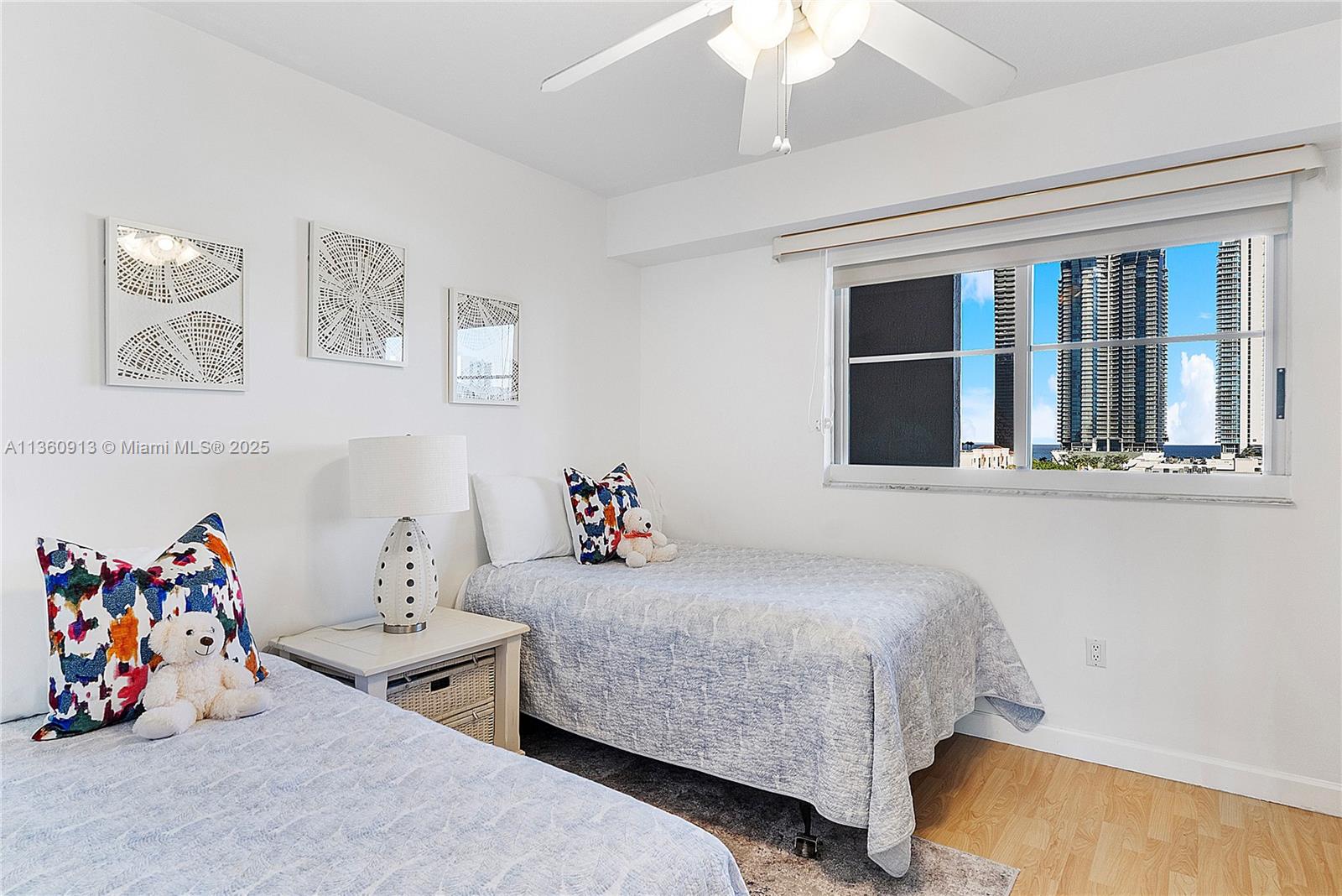 17050 North Bay Road, Unit 807 Sunny Isles Beach, FL 33160 - Photo 26 of 50 a bedroom with a bed and a window