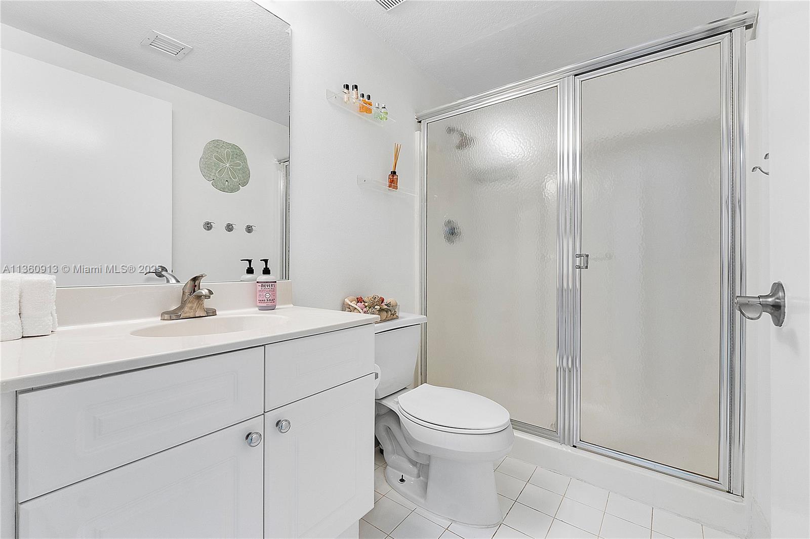 17050 North Bay Road, Unit 807 Sunny Isles Beach, FL 33160 - Photo 28 of 50 a bathroom with a sink a toilet and shower