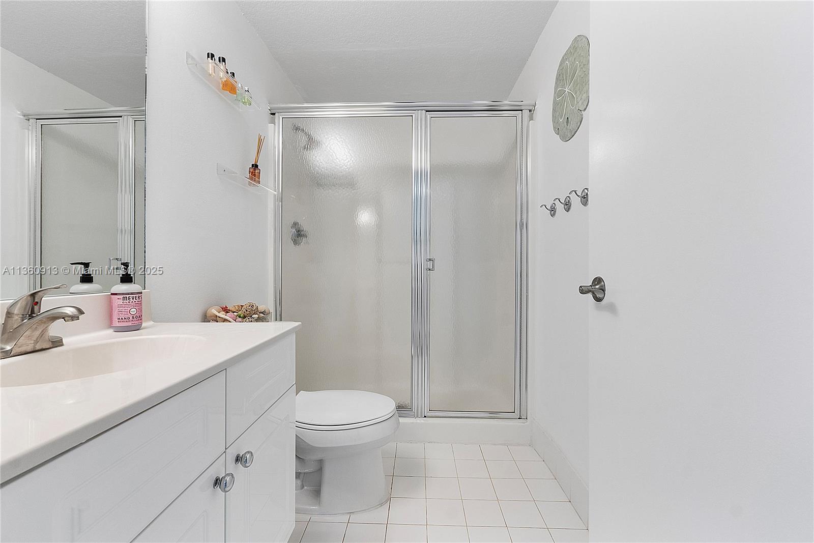 17050 North Bay Road, Unit 807 Sunny Isles Beach, FL 33160 - Photo 29 of 50 a bathroom with a sink a toilet and shower