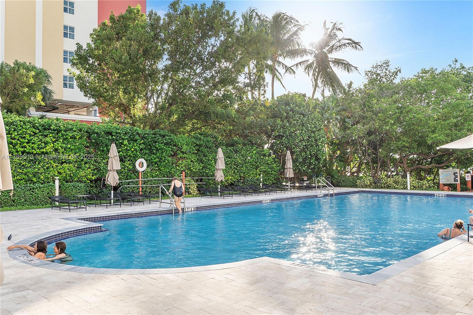 17050 North Bay Road, Unit 807 Sunny Isles Beach, FL 33160 - Photo 44 of 50 a view of a swimming pool with a yard