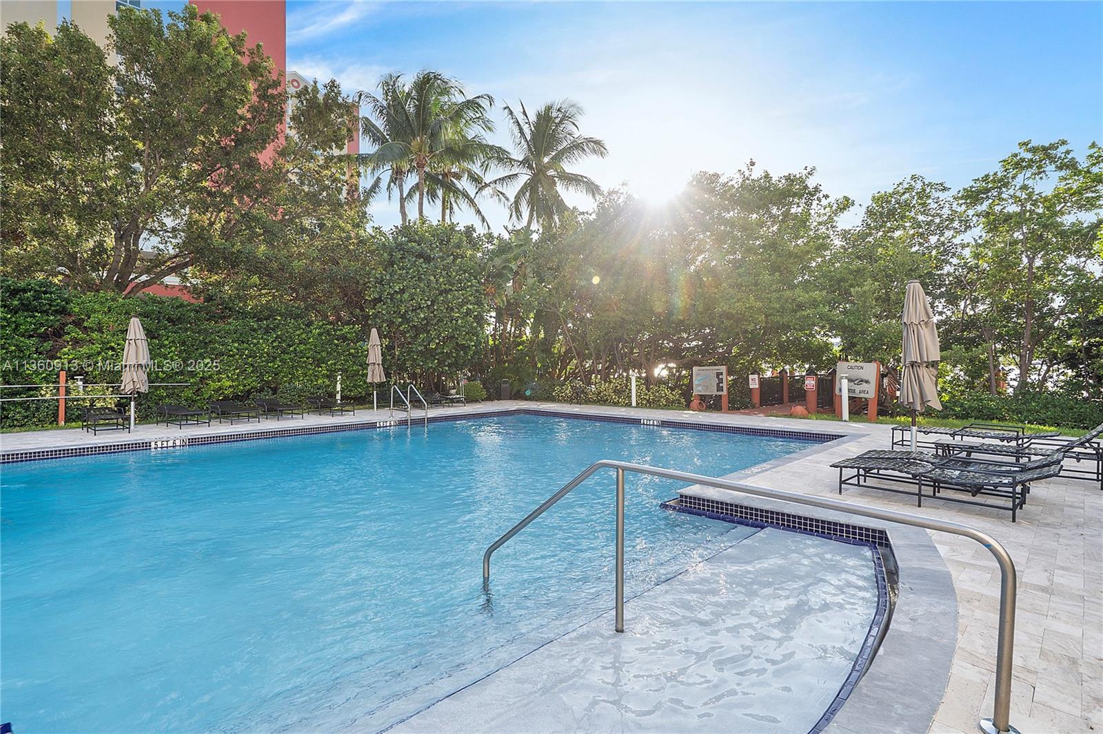 17050 North Bay Road, Unit 807 Sunny Isles Beach, FL 33160 - Photo 45 of 50 a view of a swimming pool with an outdoor space and seating area