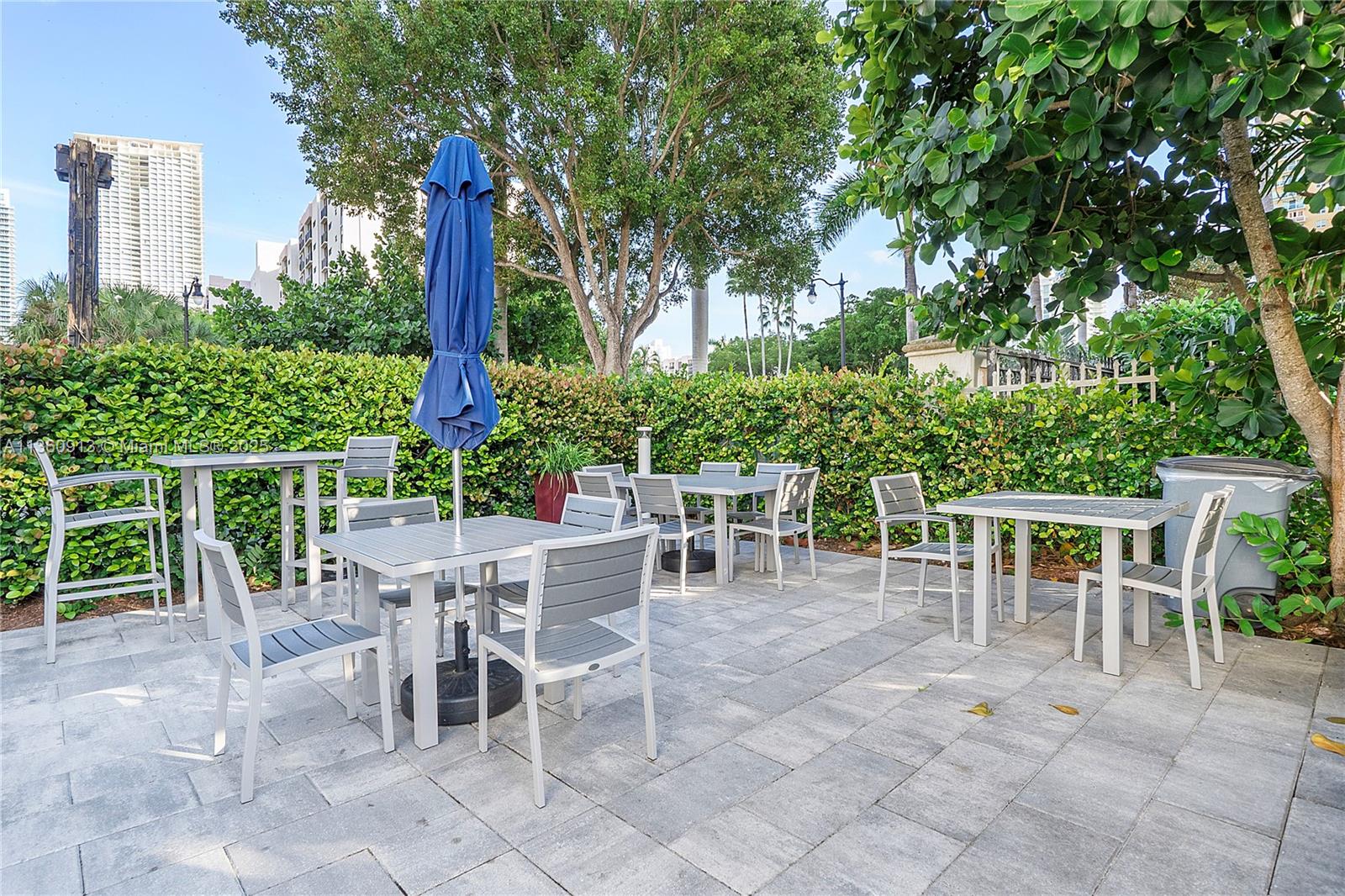 17050 North Bay Road, Unit 807 Sunny Isles Beach, FL 33160 - Photo 46 of 50 a view of a dining space with furniture and garden