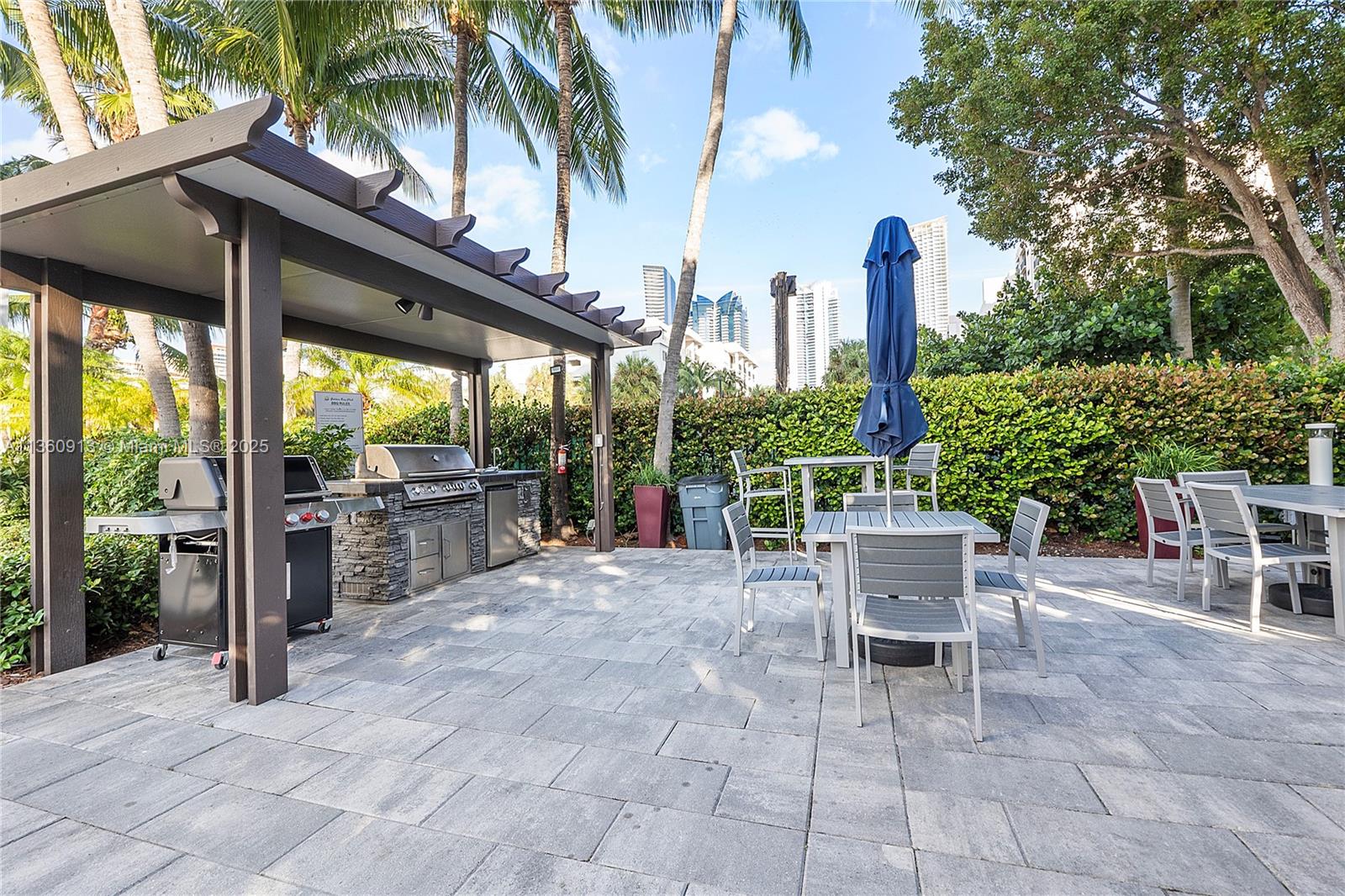 17050 North Bay Road, Unit 807 Sunny Isles Beach, FL 33160 - Photo 47 of 50 a view of a patio with a table and chairs under an umbrella