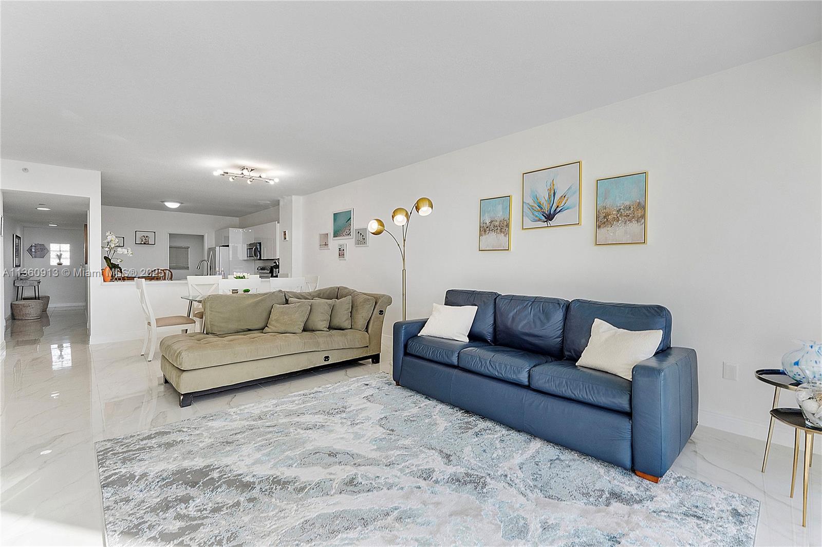 17050 North Bay Road, Unit 807 Sunny Isles Beach, FL 33160 - Photo 5 of 50 a living room with furniture and a couch
