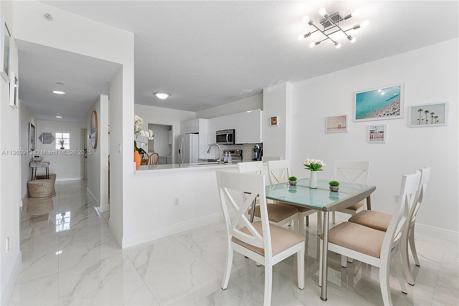 17050 North Bay Road, Unit 807 Sunny Isles Beach, FL 33160 - Photo 7 of 50 a dining room with furniture and window