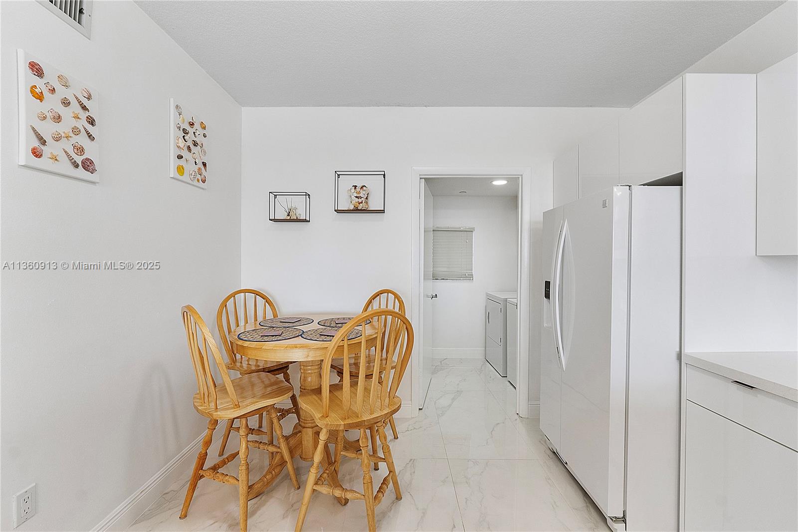 17050 North Bay Road, Unit 807 Sunny Isles Beach, FL 33160 - Photo 10 of 50 a view of a dining room with furniture and wooden floor