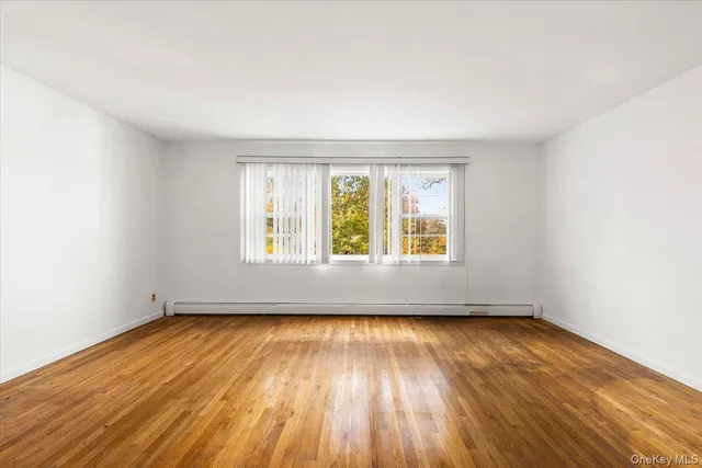 a view of work space with wooden floor and furniture