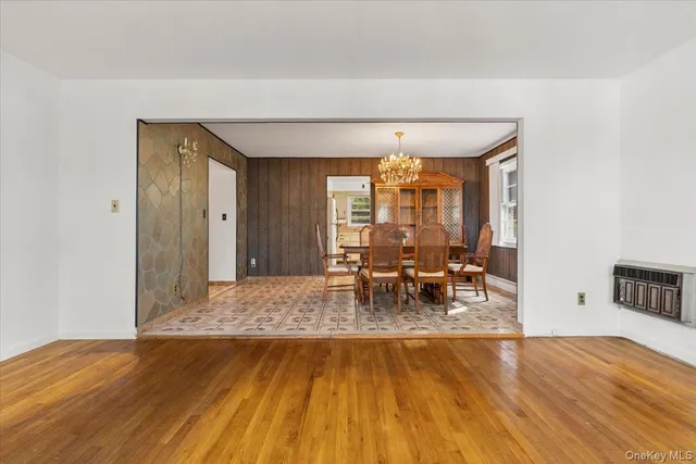 a view of a dining room with furniture and chandelier