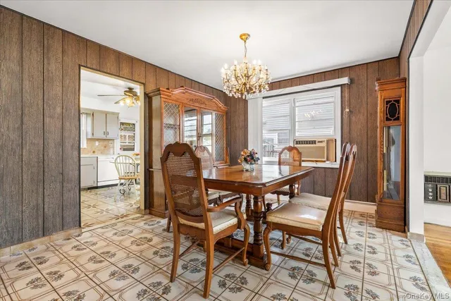 a kitchen with a dining table chairs and white cabinets