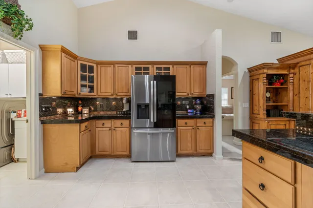 a kitchen with stainless steel appliances a refrigerator a stove a sink and dishwasher