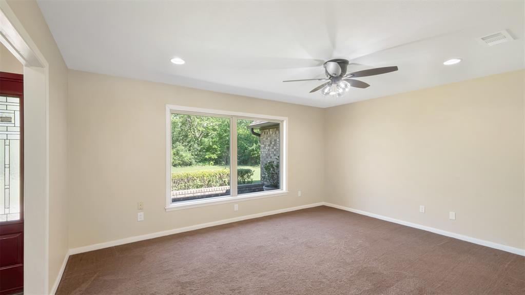 2801 Florence Street Kilgore, TX 75662 - Photo 11 of 39 an empty room with a window and a ceiling fan