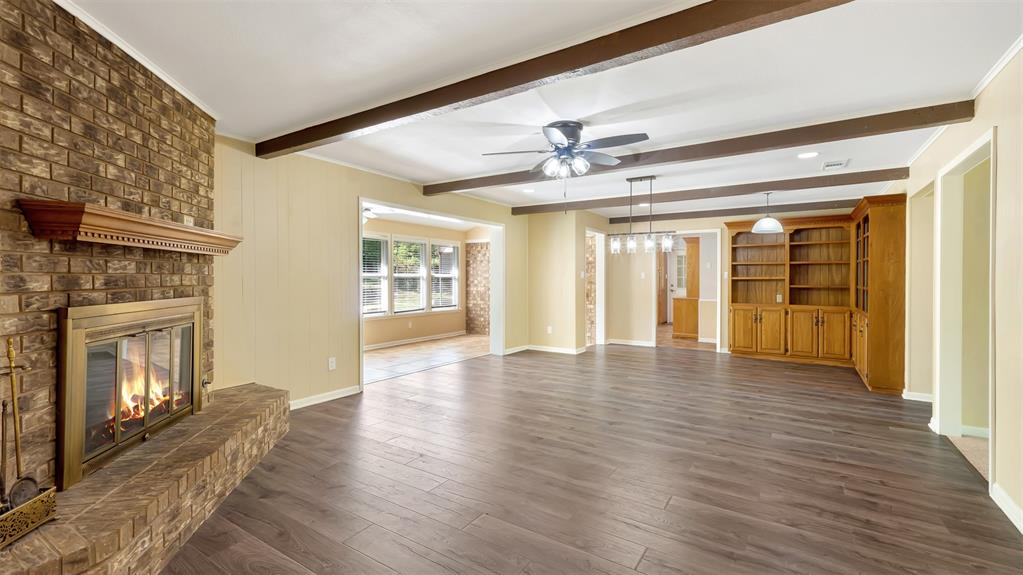 2801 Florence Street Kilgore, TX 75662 - Photo 13 of 39 a view of an empty room with wooden floor and a fireplace