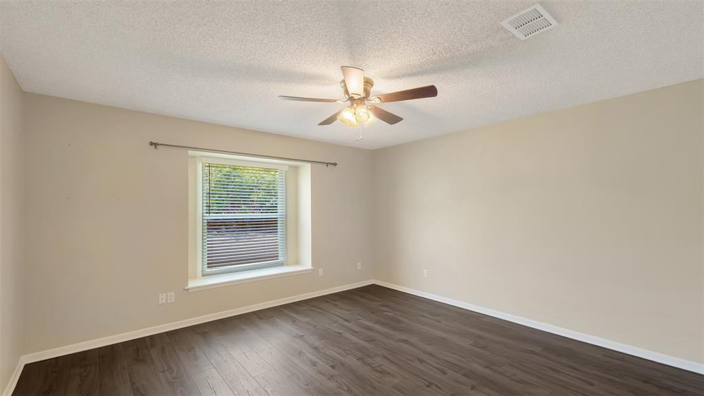 2801 Florence Street Kilgore, TX 75662 - Photo 30 of 39 wooden floor in an empty room with a window
