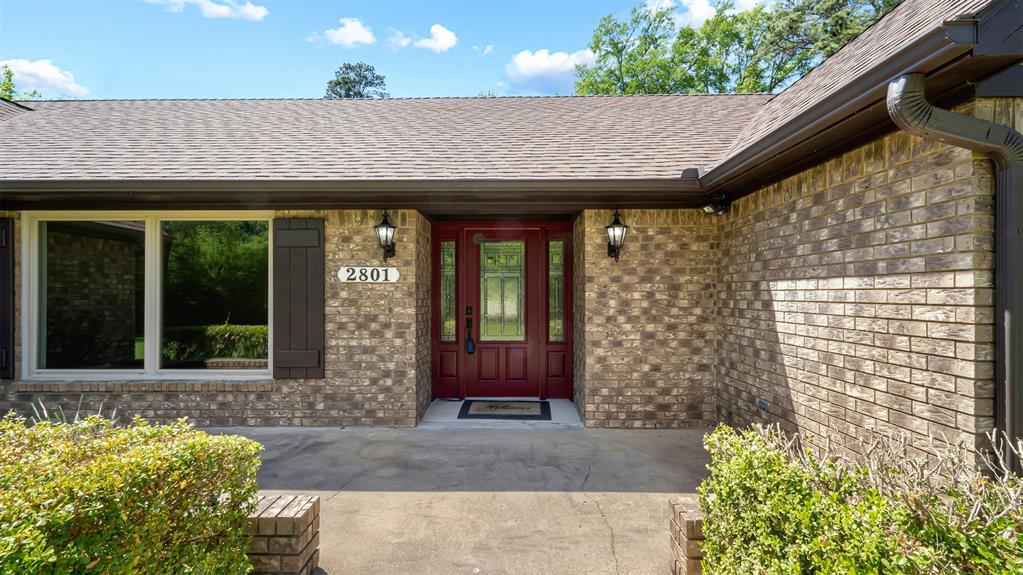 2801 Florence Street Kilgore, TX 75662 - Photo 3 of 39 a front view of a house with a garden
