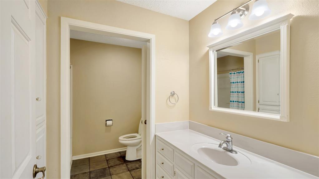 2801 Florence Street Kilgore, TX 75662 - Photo 31 of 39 a bathroom with a sink a toilet and shower