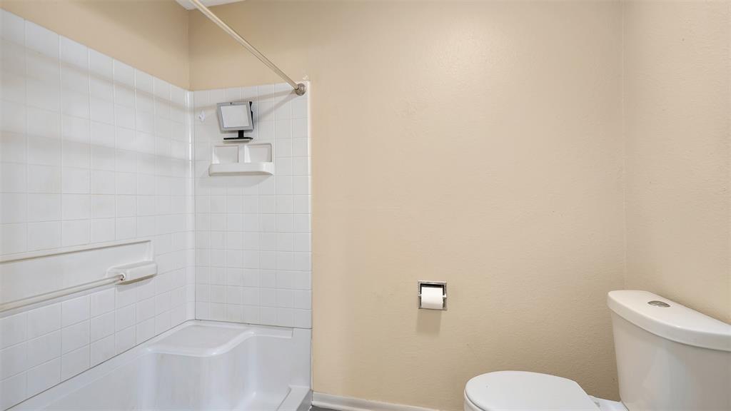 2801 Florence Street Kilgore, TX 75662 - Photo 33 of 39 a white toilet sitting next to a bath tub