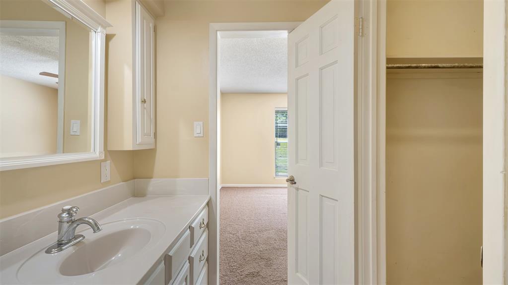 2801 Florence Street Kilgore, TX 75662 - Photo 34 of 39 a bathroom with a sink and a mirror