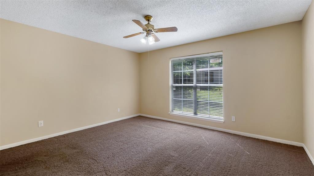 2801 Florence Street Kilgore, TX 75662 - Photo 36 of 39 an empty room with windows and fan