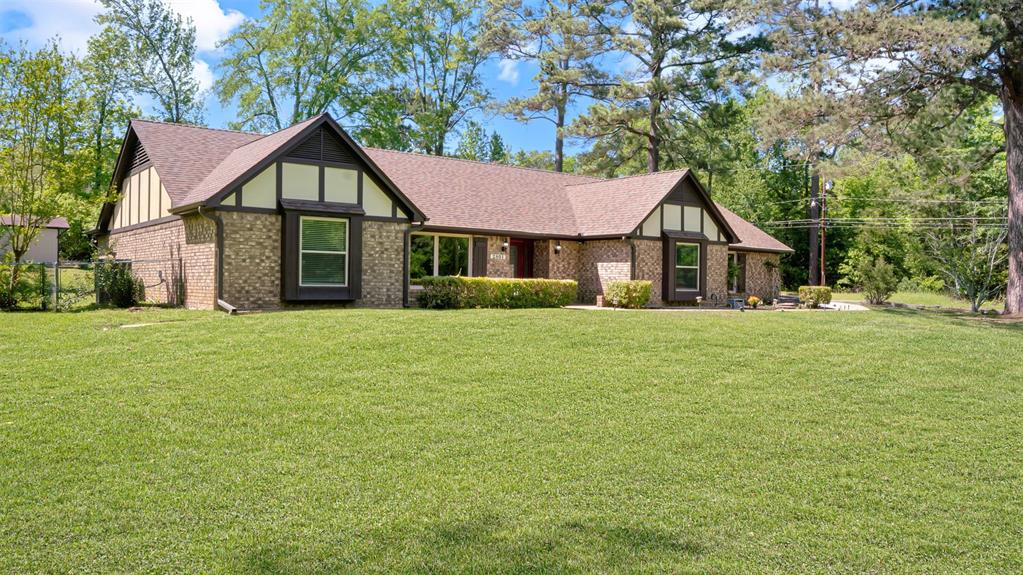2801 Florence Street Kilgore, TX 75662 - Photo 5 of 39 a front view of a house with a garden