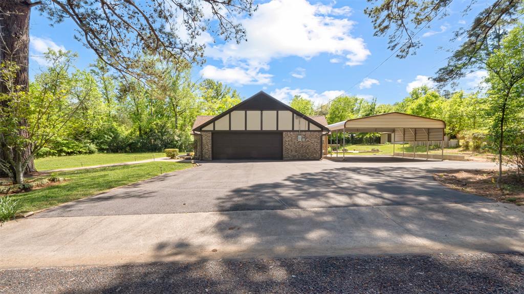 2801 Florence Street Kilgore, TX 75662 - Photo 7 of 39 a front view of a house with a garden and yard