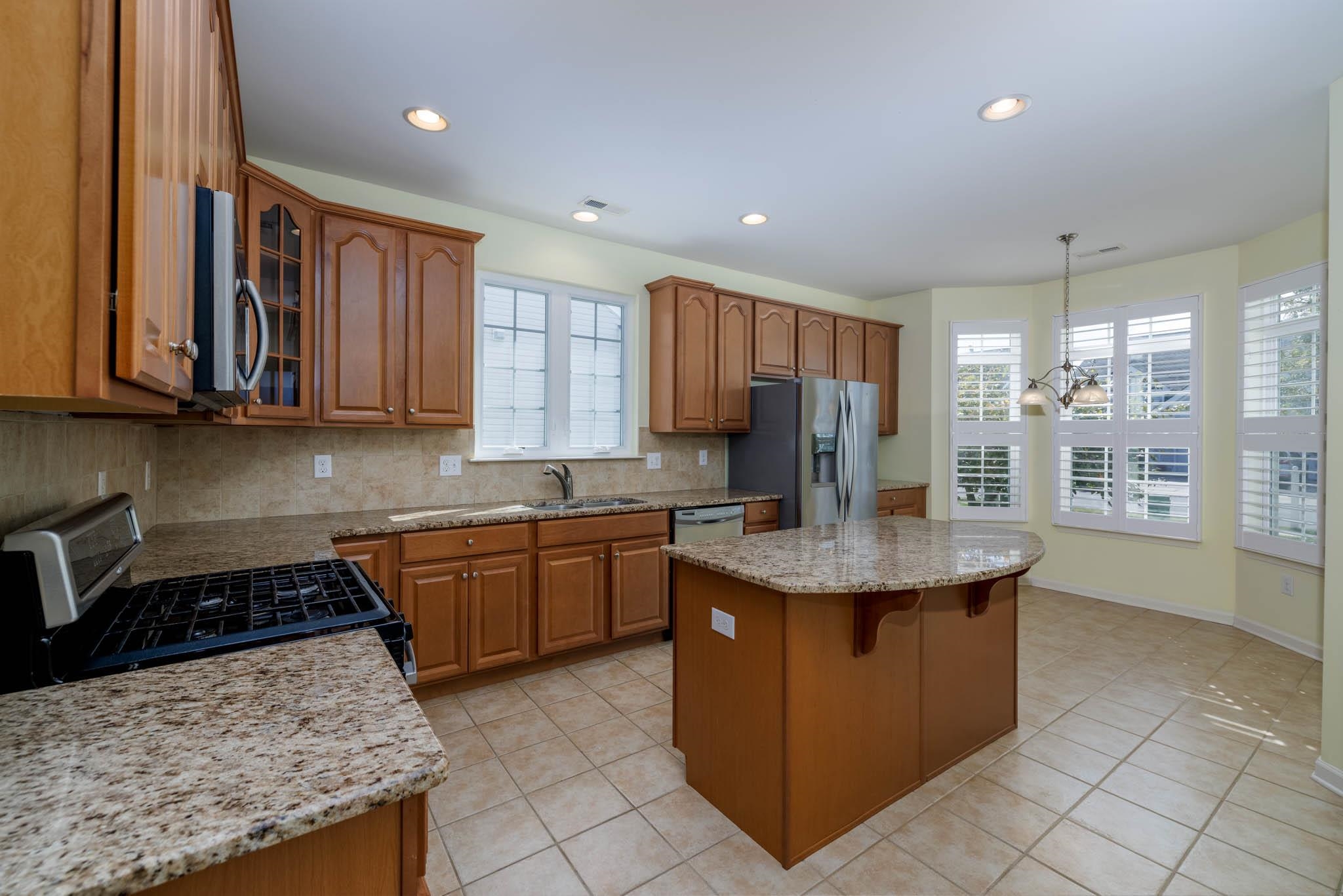 302 Aberdeen Way Rio Grande, NJ 08242 - Photo 5 of 23 a kitchen with granite countertop stainless steel appliances a sink a counter top space and cabinets