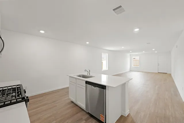 a kitchen with a sink and cabinets