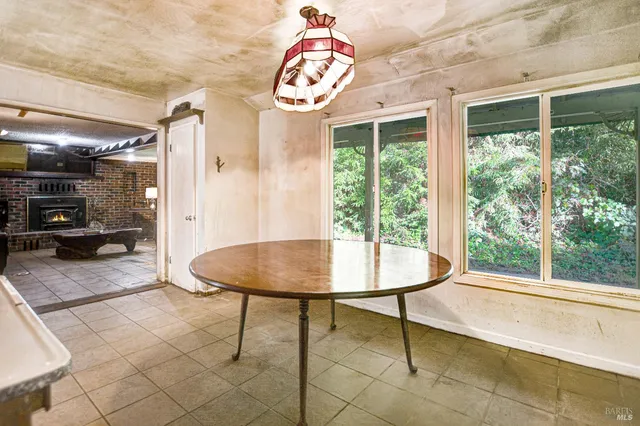 a dining room with wooden floor and a window
