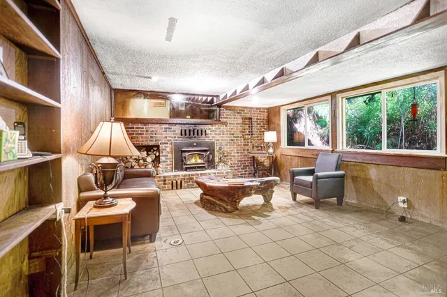 a living room with furniture a fireplace and a table